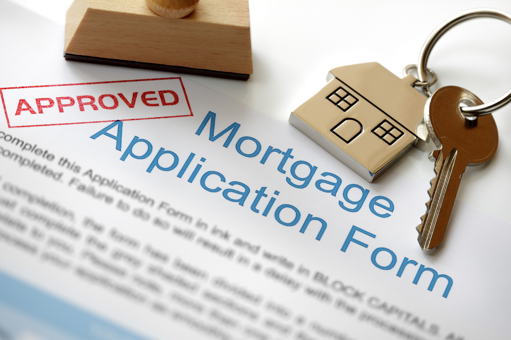 home financing: Approved Mortgage loan application with house key and rubber stamp