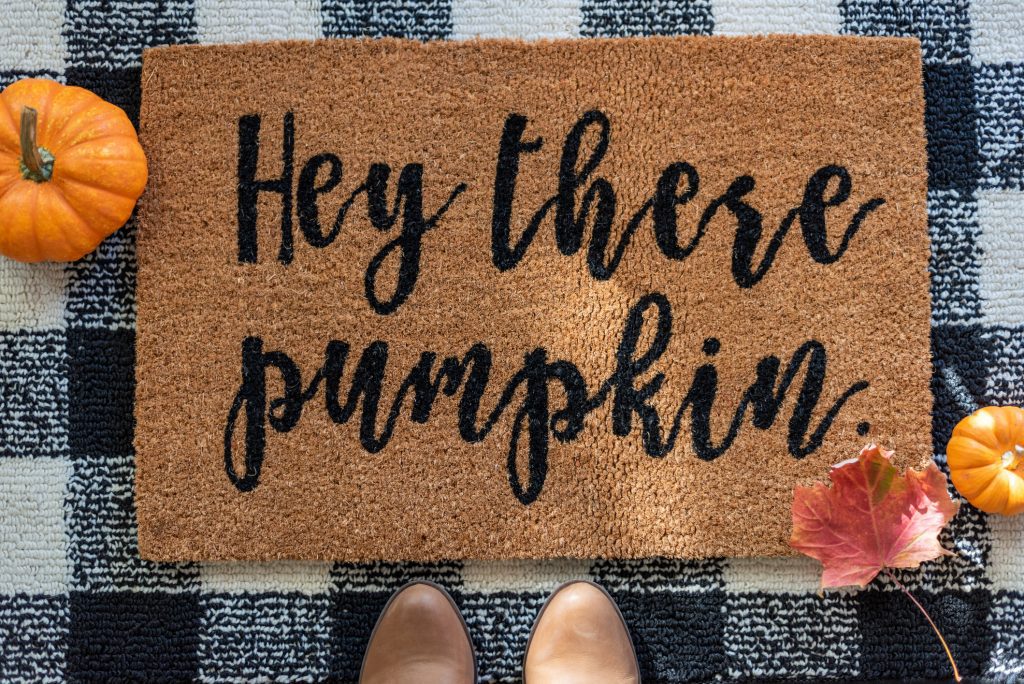 Top view of stylish fall rug with pumpkins