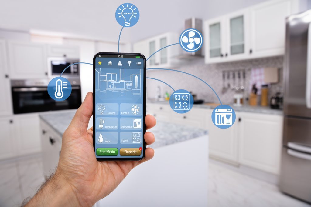 smart home, Close-up Of Man's Hand Holding Mobile With Smart Home Control Icon Feature With Kitchen Background